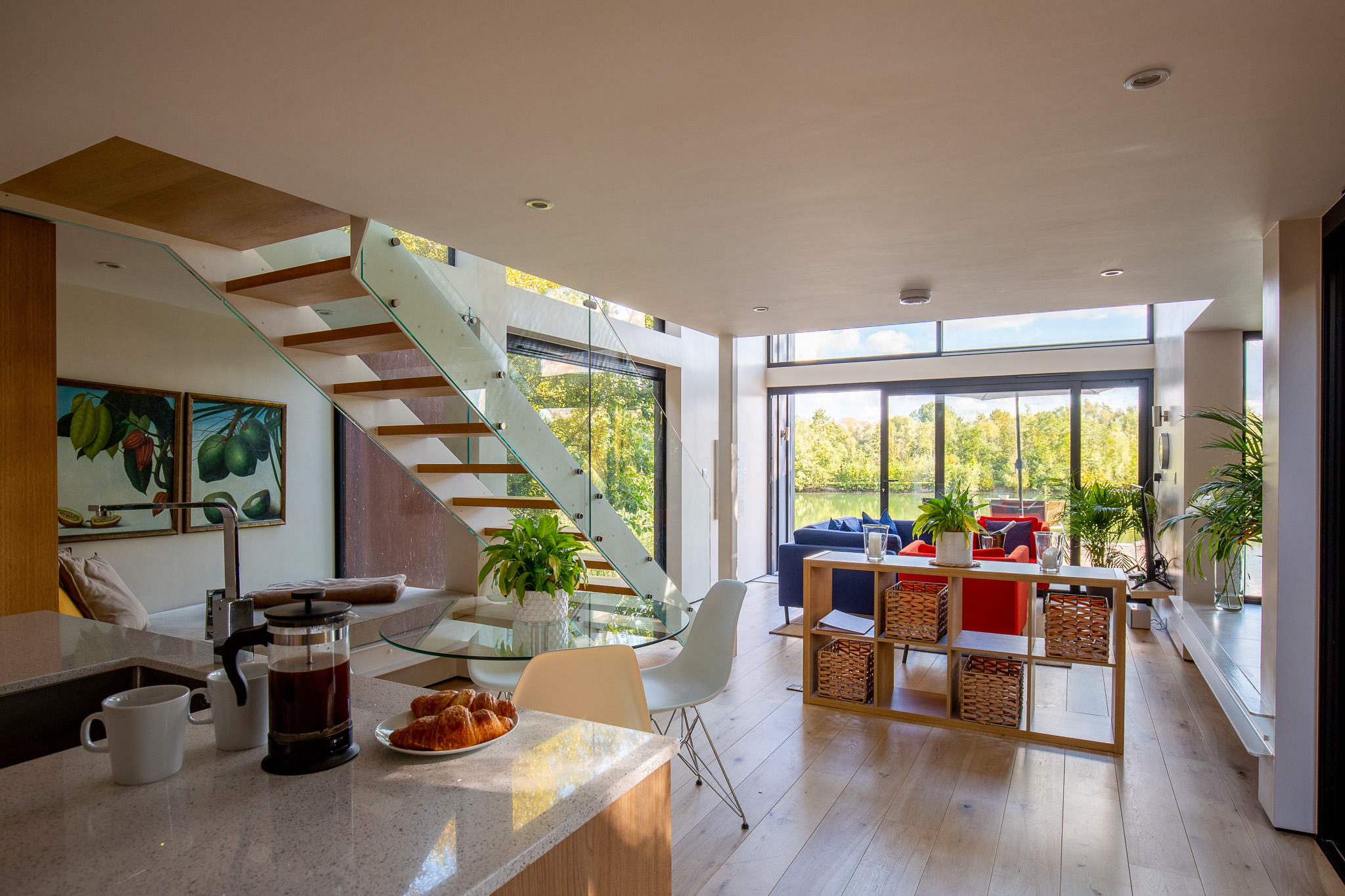 The Boathouse downstairs: kitchen-dining area-lounge-staircase-floor to-ceiling glass sliding door
